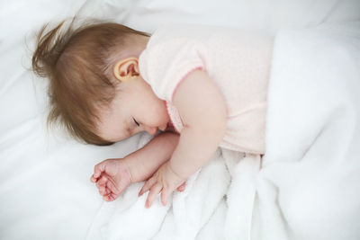 Cute baby sleeping on bed