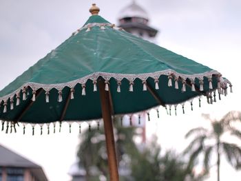 Low angle view of traditional umbrella against sky