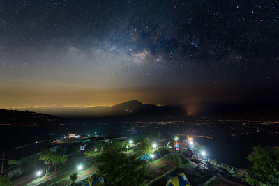 Illuminated city against sky at night