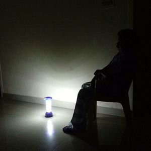 Man sitting in illuminated room