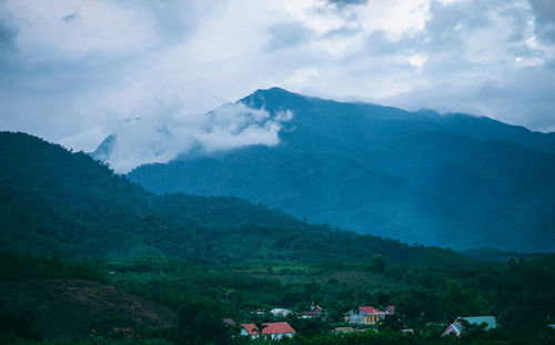 Scenic view of mountains against cloudy sky
