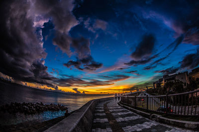 Road against dramatic sky during sunset