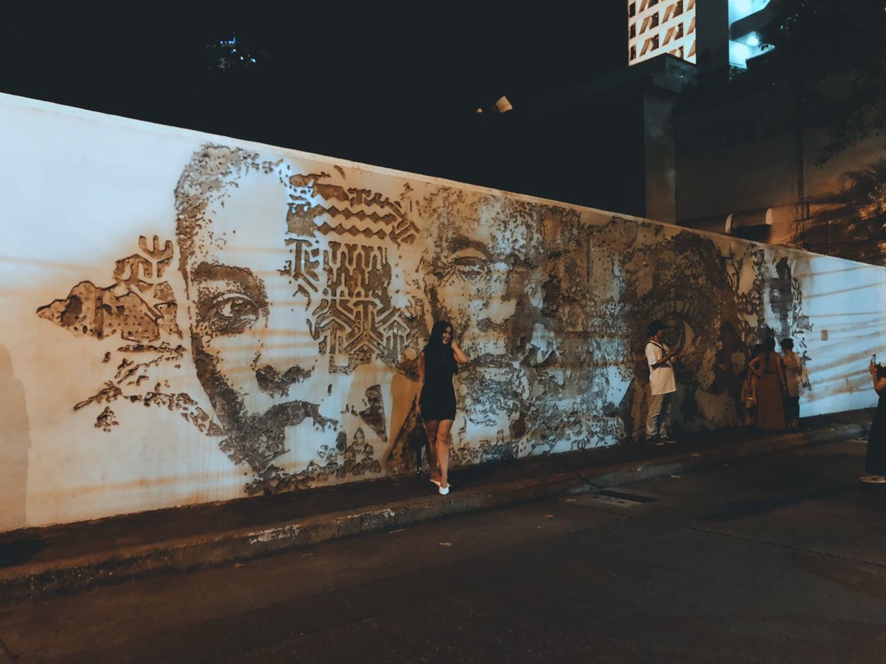 GRAFFITI ON WALL BY ILLUMINATED CITY