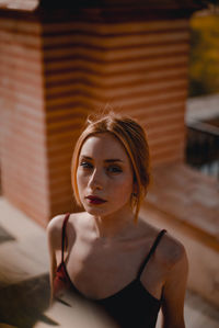 Portrait of young woman sitting outdoors