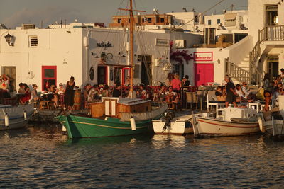 Group of people on boats in city