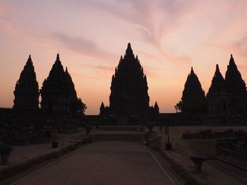 Temple against sky at sunset