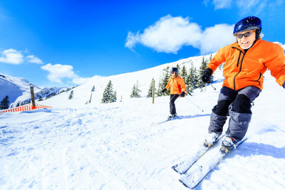 View of person skiing on snowcapped mountain
