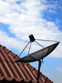 Low angle view of telephone roof against sky