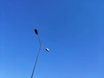 Low angle view of street light against clear blue sky