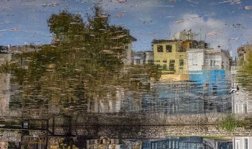 Reflection of buildings on puddle