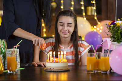 People in front of illuminated cake