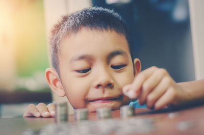 Close-up portrait of cute boy at table