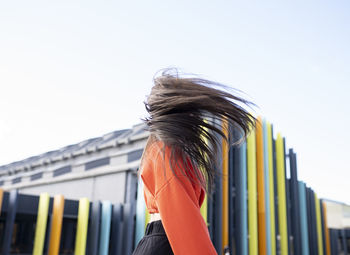 Portrait of long-haired brunette tossing hair