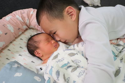 Close-up of baby sleeping on bed