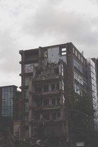 Low angle view of building against cloudy sky