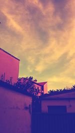 Low angle view of house against cloudy sky