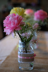 Close-up of pink flower vase on table
