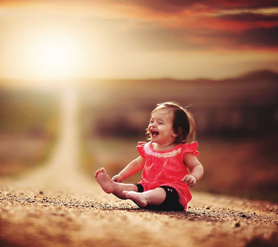 SMILING GIRL PLAYING ON GRASS