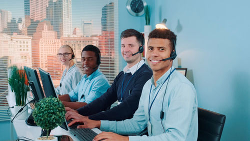 Portrait of young woman using laptop at home