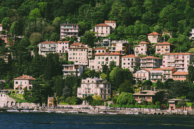 Buildings by river in town