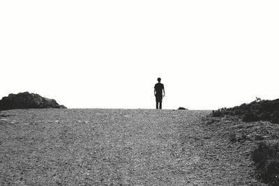 Rear view of woman standing by tree