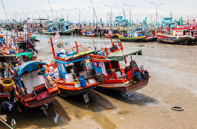 Boats moored at harbor in city