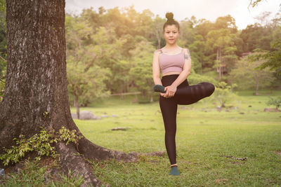 Young woman exercising in forest