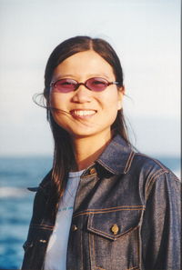 Portrait of smiling woman against sea