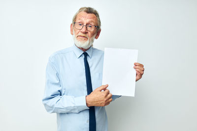 Portrait of senior man holding paper