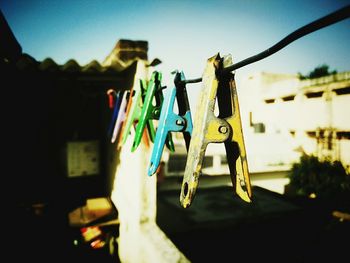 Low angle view of clothes hanging on clothesline against sky