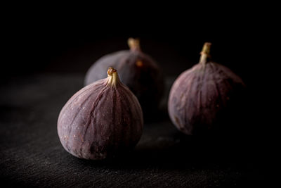 Close-up of fruits on table against black background