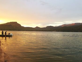 Scenic view of lake against sky during sunset