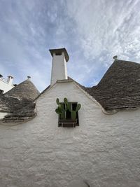 Low angle view of old building against cloudy sky