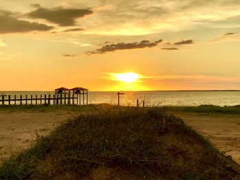 Scenic view of beach against sky during sunset