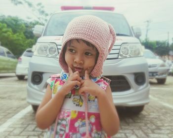 Portrait of cute girl in car