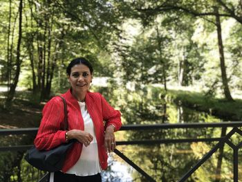 Portrait of a smiling young woman in forest