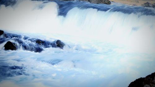 Close-up of waterfall against sky during winter