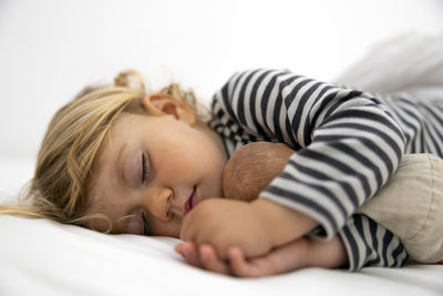 High angle view of baby sleeping on bed