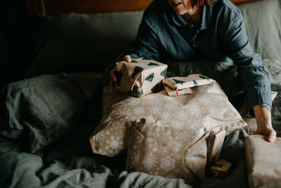 Midsection of woman with gift boxes