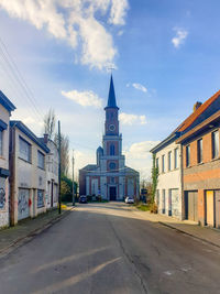 Street amidst buildings against sky in city