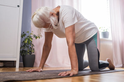 Side view of woman exercising in gym