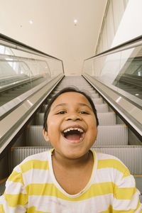 Close-up of boy on escalator