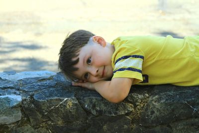 Portrait of boy smiling on rock