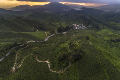 High angle view of green landscape against sky