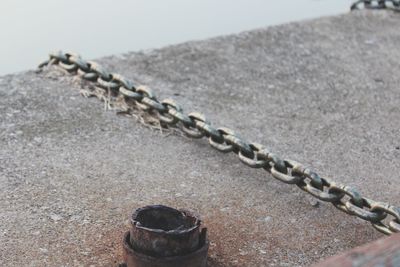 Close-up of chain on sand