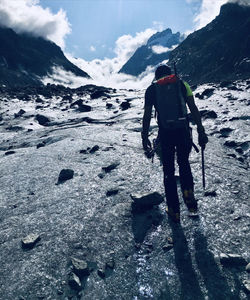 Rear view of person on snowcapped mountain