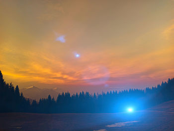 Scenic view of silhouette trees against orange sky