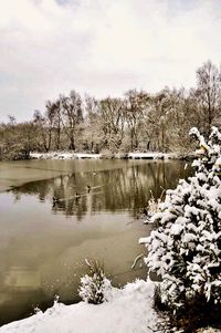 Scenic view of lake against sky during winter