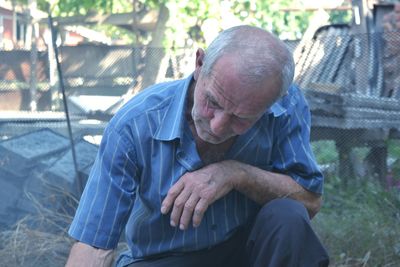 Thoughtful man sitting on field