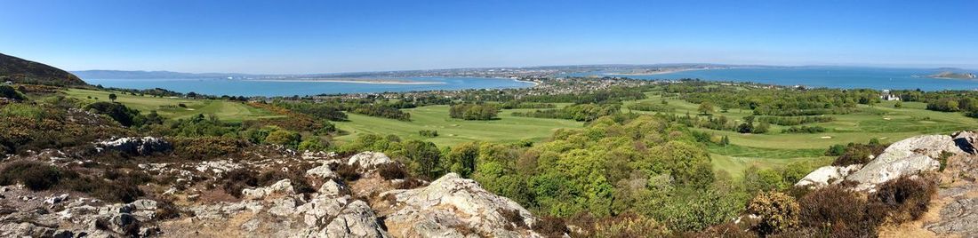 Panoramic view of landscape against blue sky